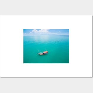 Aerial view of fishing boat on emerald sea Posters and Art